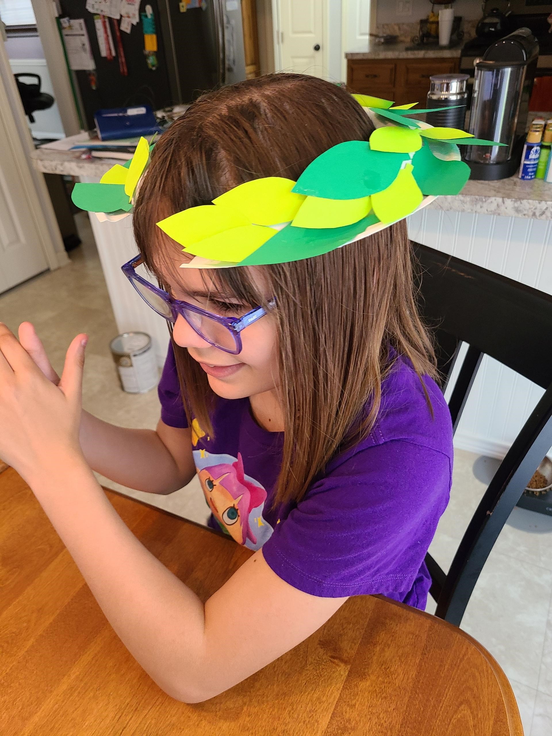 Girl wearing a hat she made.